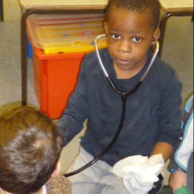 A doctor checking his patient's heart rate using a stethoscope